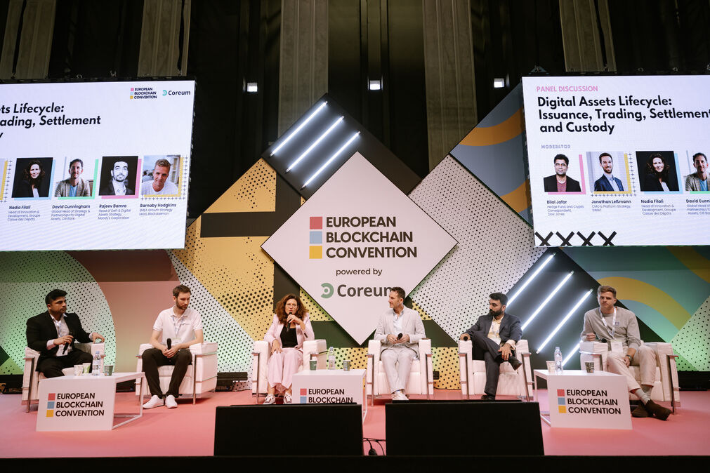 Photo of a panel of experts speaking at the European Blockchain Convention 