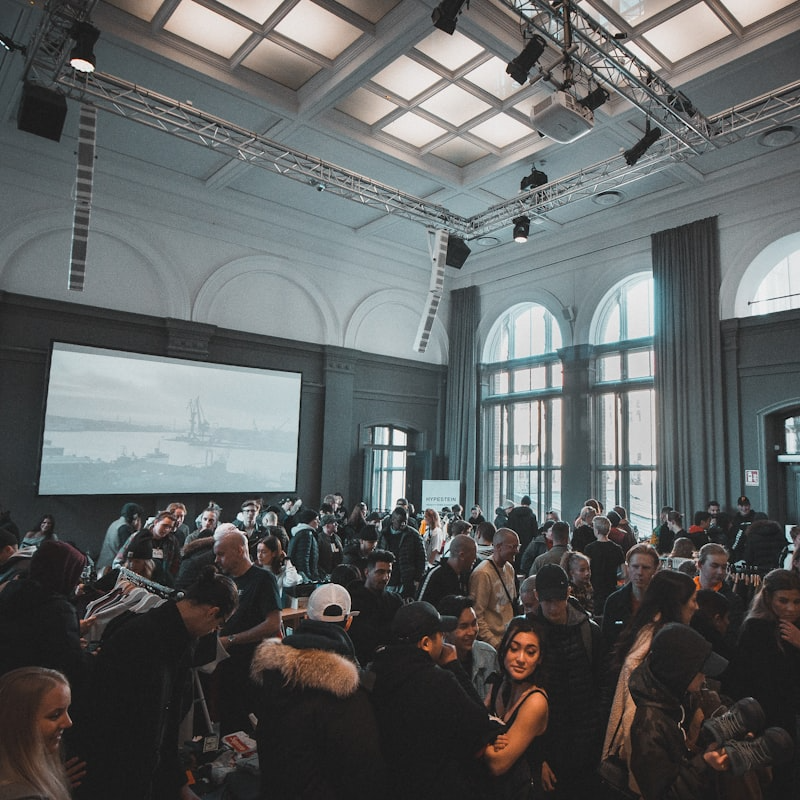 Busy networking event at the 4YFN Founders Meetup, with a crowd engaging in conversations inside a venue with high ceilings and large windows.