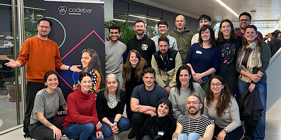 Group photo from a Codebar Barcelona free coding workshop, featuring a group of attendees and mentors smiling in a collaborative workspace.